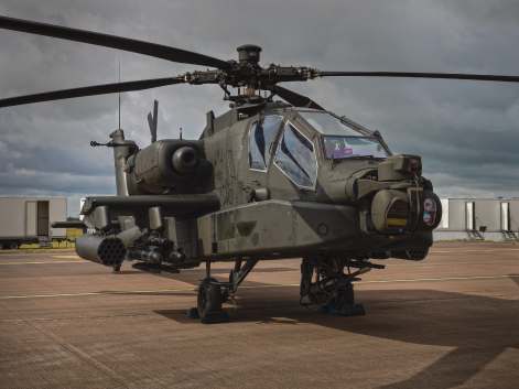 Apache helicopter parked on an airfield